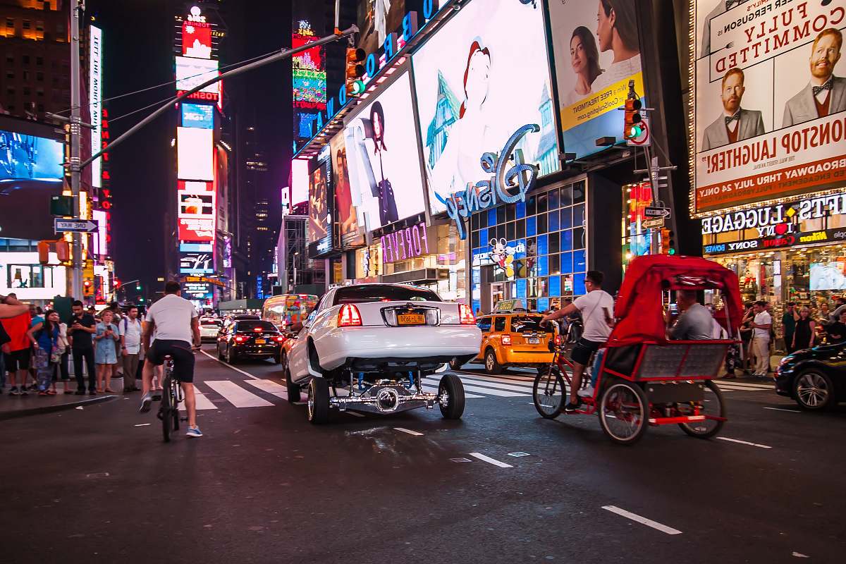times square vehicle on road at night-time new york